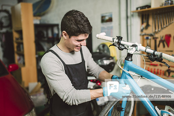 Mechanic repairing a bicycle in his workshop