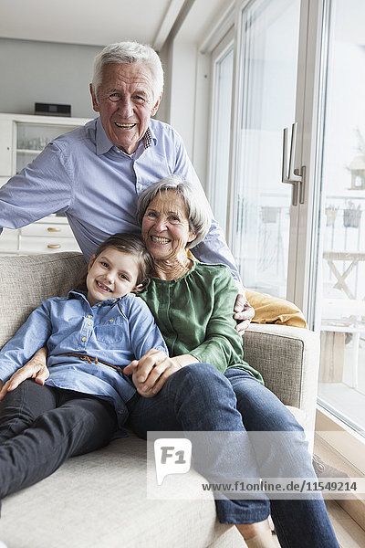 Family portrait of grandparents and their granddaughter at home