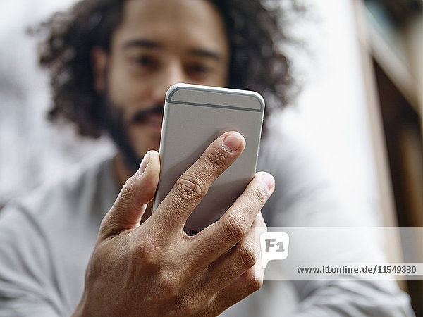 Young man holding cell phone