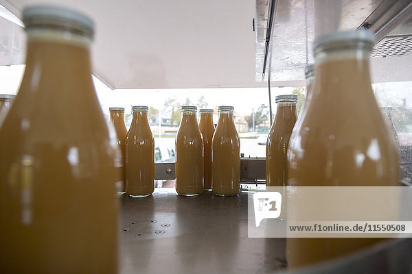 Apple juice is being bottled in a bottling plant