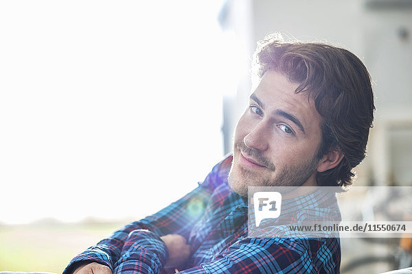 Portrait of relaxed young man at backlight