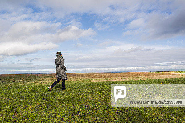 France  Bretagne  Finistere  Crozon peninsula  woman walking on meadow at the coast