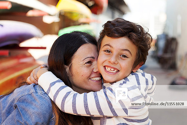 Spain  Barcelona  portrait of happy little boy hugging his mother