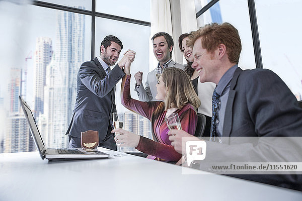 Business people celebrating success in office