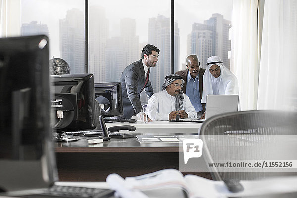 Western businessmen having meeting in Middle Eastern office