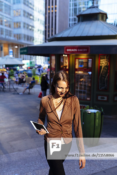 USA  New York  Manhattan  smiling young businesswoman with tablet in the evening
