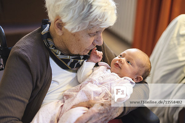 Old woman meeting her great granddaughter
