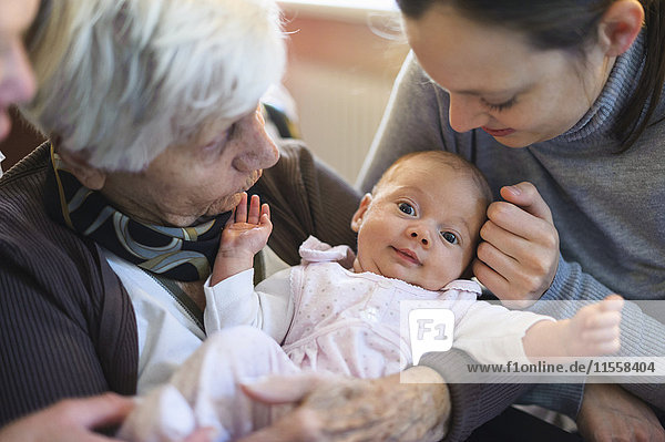 Old woman meeting her great granddaughter