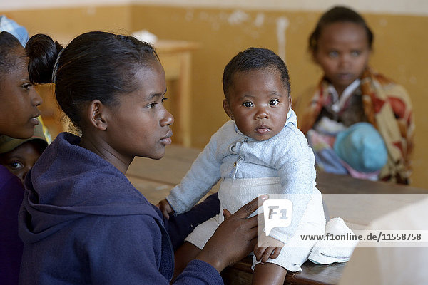 Madagascar  Fianarantsoa  Young mother with baby boy attending mother and child group