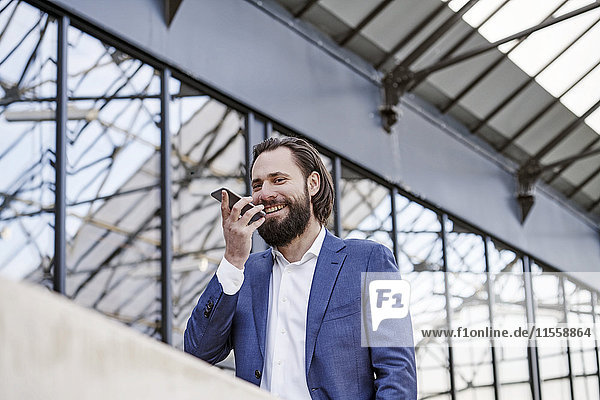 Smiling businessman using cell phone