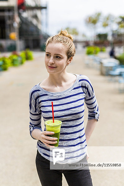 USA  New York City  confident woman drinking a smoothie in Manhattan