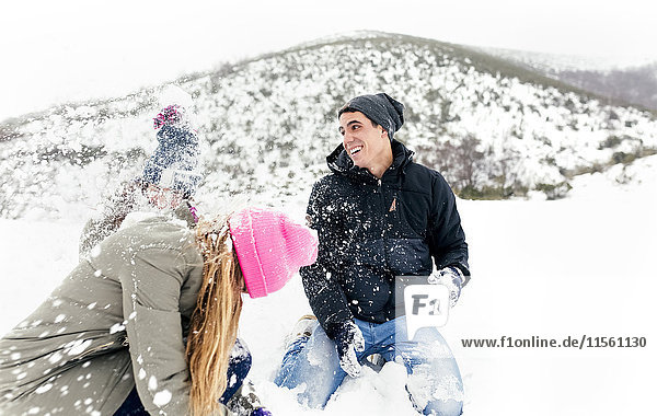 Friens having a snowball fight in the snow