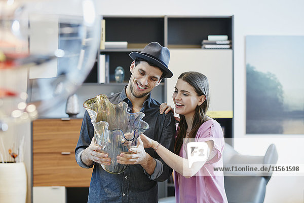 Couple in furniture store looking at vase