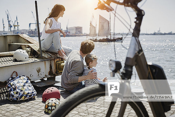 Germany  Hamburg  family having a break from a bicycle tour at River Elbe