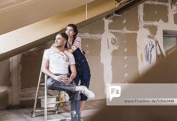 Young couple on construction site of their new home