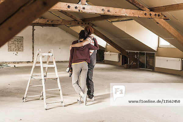 Young couple renovating their new home  looking at construction site