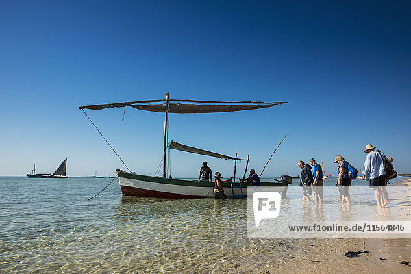 'Tourists getting on a Dhow in Vilanculos beach  Bazaruto Archipelago; Mozambique'