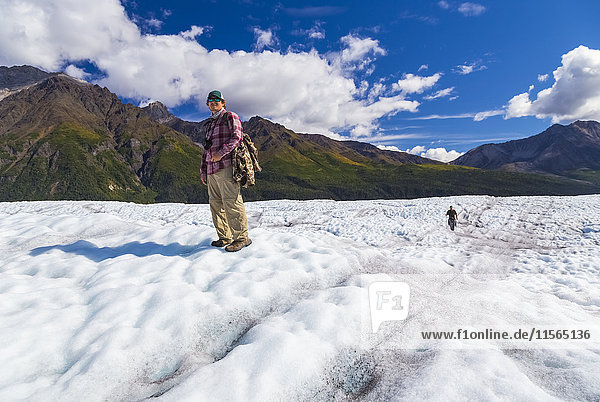 Hikers cross Root Glacier on a summer day in Wrangell-St. Elias National Park  Southcentral Alaska  USA