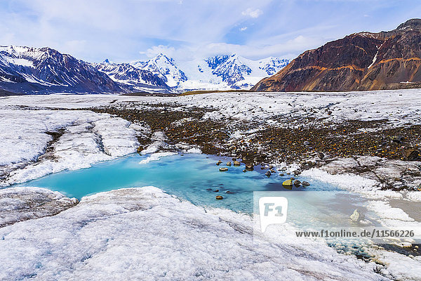 'A turquoise pool of water lies on the surface of Gakona Glacier in the Alaska Range; Alaska United States of America'