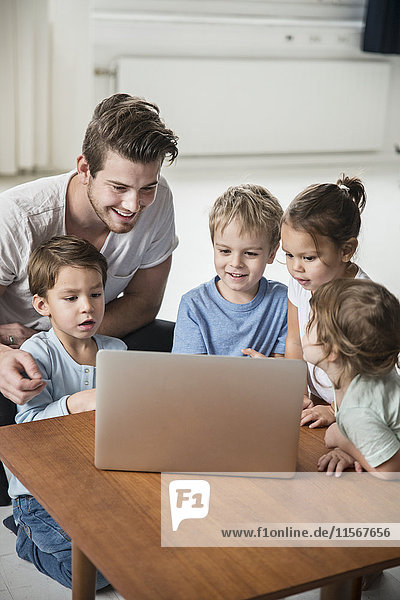 Male preschool using laptop in preschool