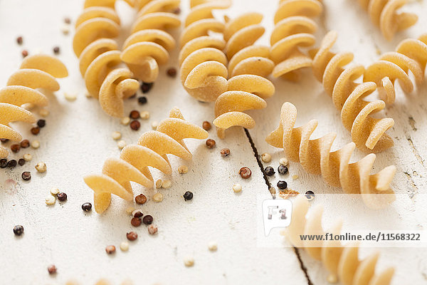 Pasta and quinoa on white background