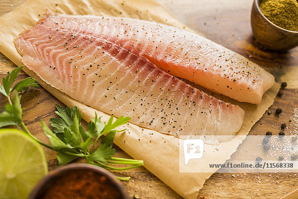 Raw tilapia on cutting board
