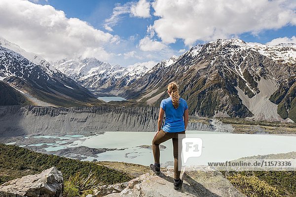 Hiker standing on rocks  view into the Hooker Valley from Sealy Tarns Track  glacial lakes Mueller Lake and Hooker Lake  Mount Cook National Park  Canterbury Region  South Island  New Zealand  Oceania