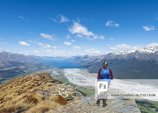 Hiker overlooking Lake Wakatipu from Mount Alfred  Glenorchy at Queenstown  Southern Alps  Otago  Southland  New Zealand  Oceania