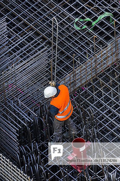 Bauarbeiter beim Verarbeiten von Bewehrungsstahl für eine Stahlbetondecke Bayern Deutschland Europa