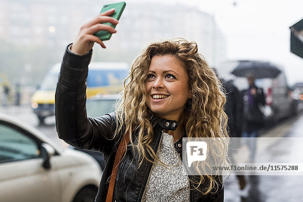 Woman in street taking selfie