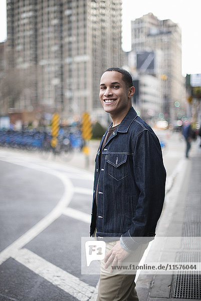 Portrait of young man standing in street  Manhattan  New York  USA
