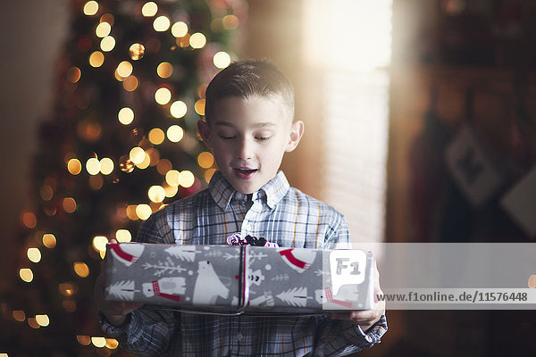 Young boy holding christmas gift