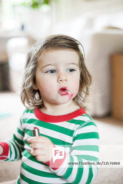 Baby girl playing with lipstick