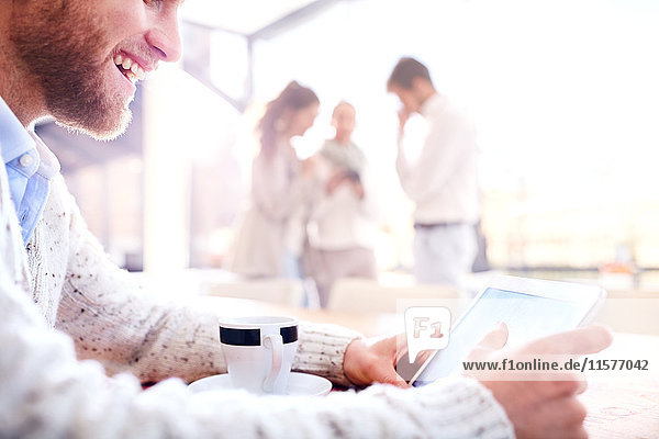 Young businessman looking at digital tablet in office