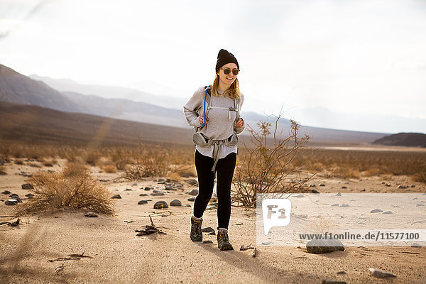 Trekker running in Death Valley National Park  California  US