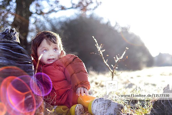Porträt eines kleinen Jungen  im Freien sitzend  im Winter