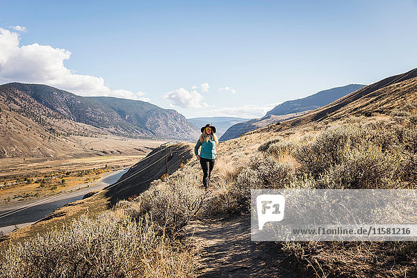 Woman hiking  Trans Canada Highway  near Kamloops  Boston Flats  British Columbia  Canada