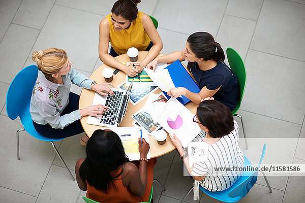 High angle view of business women sitting at table in meeting