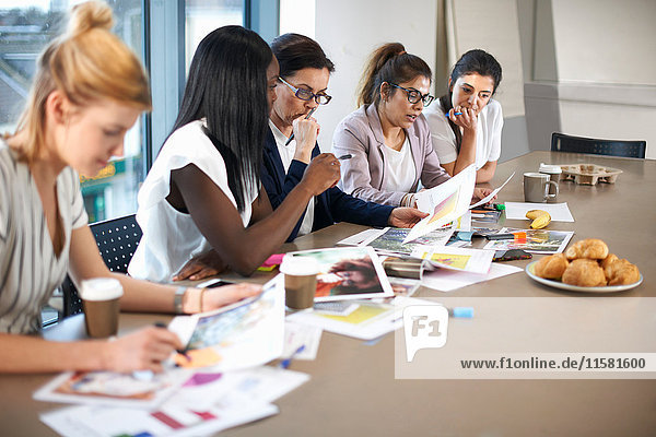 Colleagues having meeting at conference room table