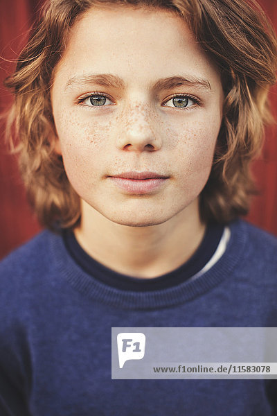Portrait of confident teenage boy in back yard