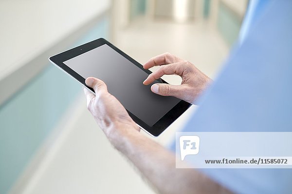 Surgeon using digital tablet  close up.