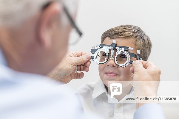 Male optician testing boy's eyesight.