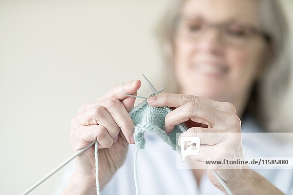 Senior woman knitting.