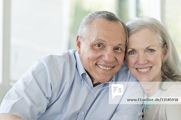 Portrait of senior couple smiling towards camera.