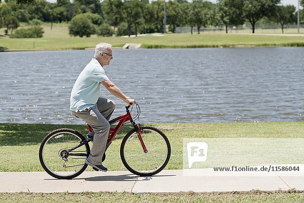 Senior man riding a bicycle.