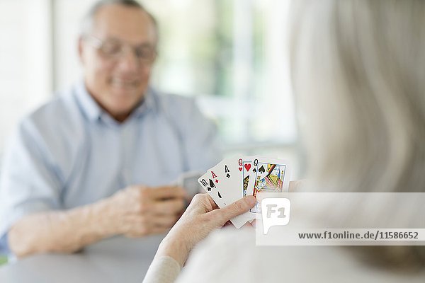 Senior couple playing cards.