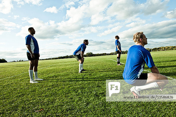 Soccer players standing on pitch