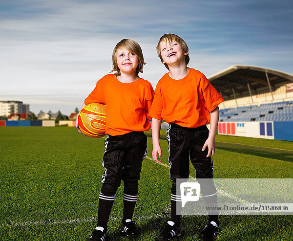 Boys on soccer team standing on pitch
