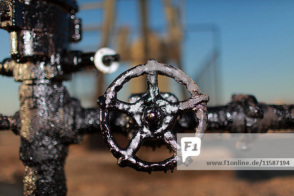 Close up of grimy wheel at oil field
