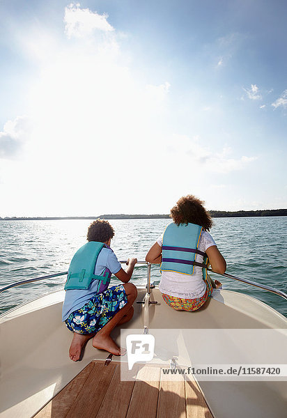 Two children looking at view from motorboat